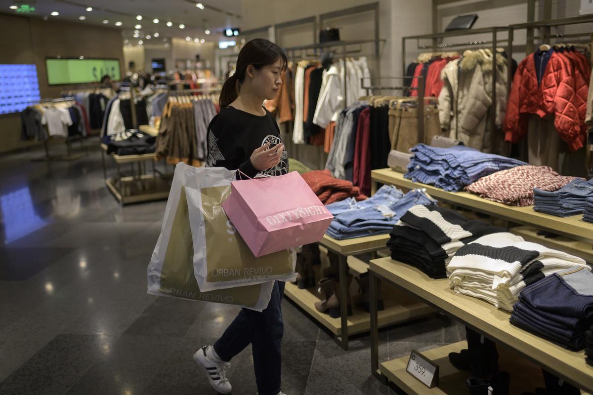 A customer shops for clothing at a mall in Beijing on Jan. 16, 2019. (Nicholas Asfouri/AFP/Getty Images)