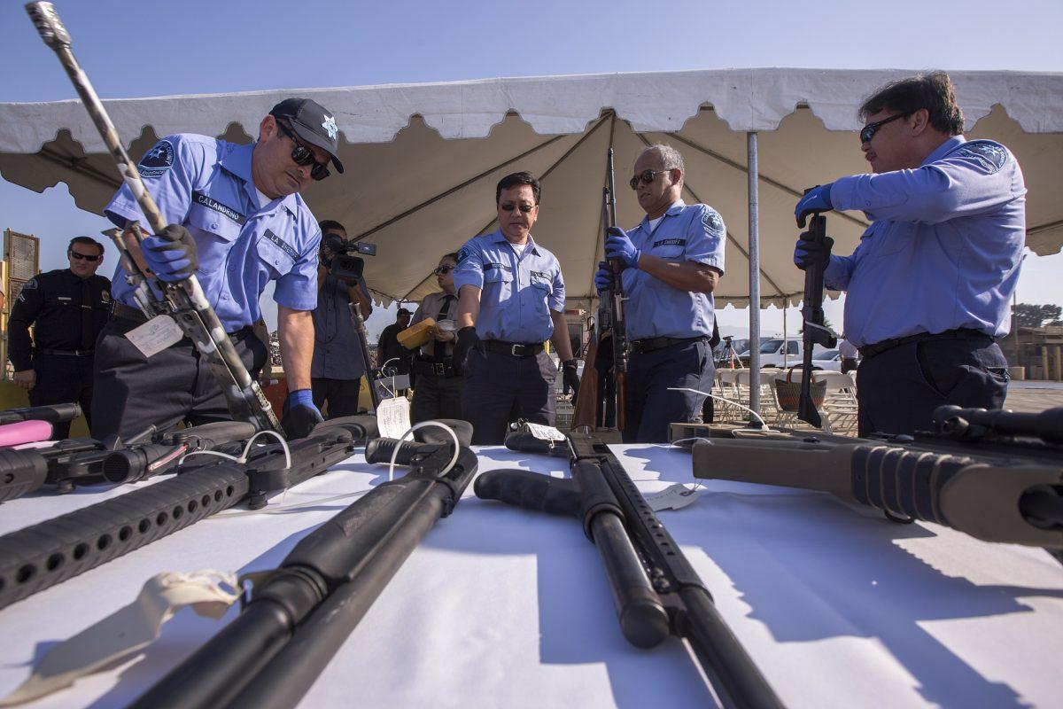 Deputies handle some of the approximately 3,500 confiscated guns to be melted down at Gerdau Steel Mill in Rancho Cucamonga, Calif., on July 19, 2018. (David McNew/Getty Images)