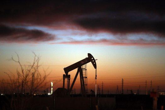 An oil pumpjack works at dawn in the Permian Basin oil field on Jan. 20, 2016, in the oil town of Andrews, Texas. (Spencer Platt/Getty Images)