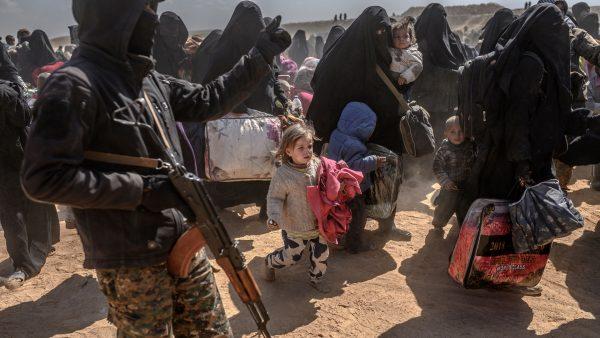 Women and children evacuated from the ISIS terrorist state group's embattled holdout of Baghouz arrive at a screening area held by the US-backed Kurdish-led Syrian Democratic Forces (SDF), in the eastern Syrian province of Deir Ezzor, on March 6, 2019. (Bulent KILIC/AFP)