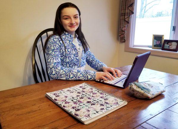 Meredith Kass, a senior at Kellenberg Memorial High School in Uniondale, works on her school assignments at her home in Seaford, N.Y. (Photo by Rolyne Joseph)