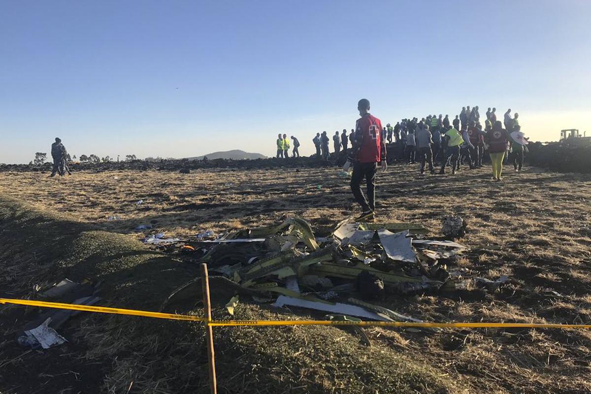 Rescuers search at the scene of an Ethiopian Airlines flight that crashed shortly after takeoff at the scene at Hejere near Bishoftu, or Debre Zeit, some 50 kilometers (31 miles) south of Addis Ababa, in Ethiopia Sunday, March 10, 2019. (AP Photo/Yidnek Kirubel)