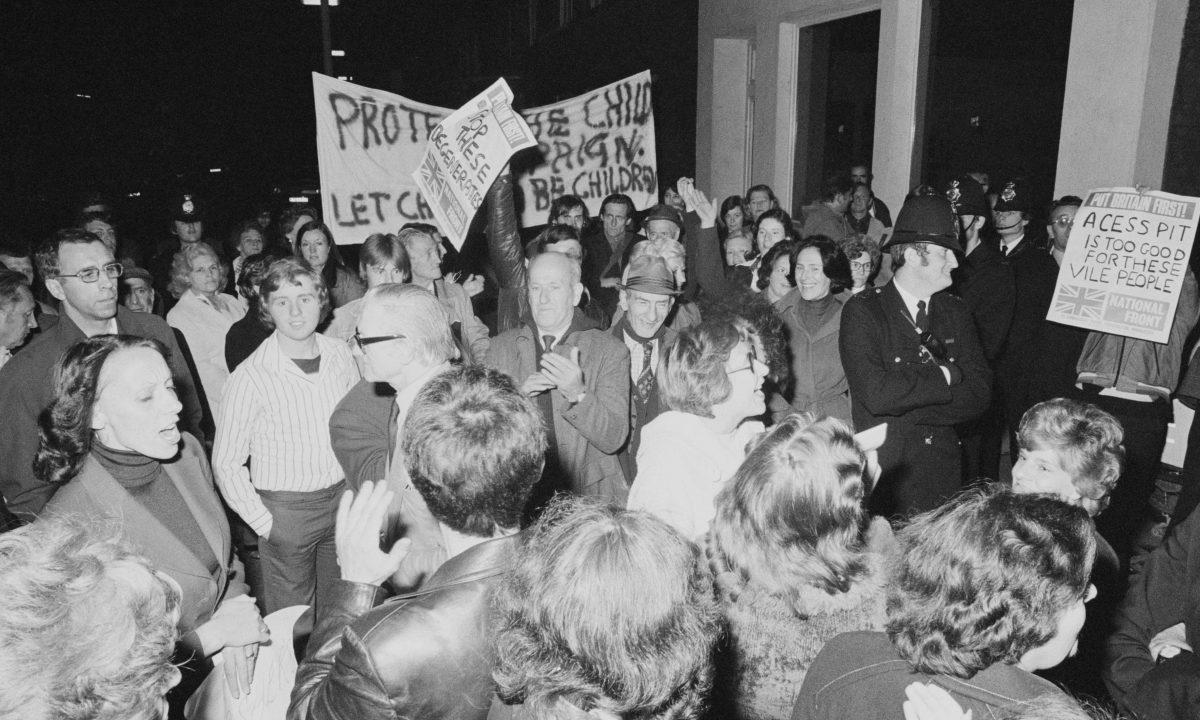 Protesters and police outside Conway Hall as the pro-pedophile activist group, the Paedophile Information Exchange (PIE) held its first open meeting in London on Sept. 19, 1977. (Malcolm Clarke/Keystone/Hulton Archive/Getty Images)