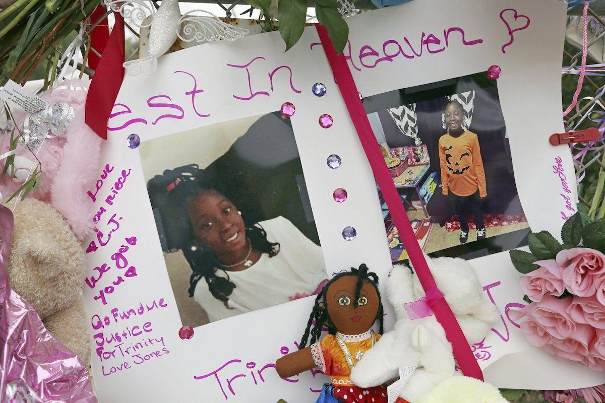 Photos adorn a large memorial to Trinity Love Jones, on March 11, 2019, the 9-year-old girl whose body was found in a duffel bag along a suburban Los Angeles equestrian trail, in Hacienda Heights, Calif. (Reed Saxon/AP Photo)