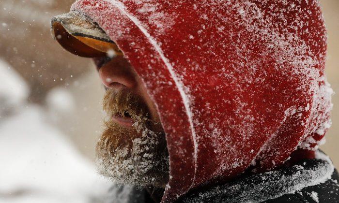 Joe Miller's beard freezes over as he walks through downtown Casper, Wyo., during a winter storm on March 13, 2019. (Josh Galemore/The Casper Star-Tribune via AP)