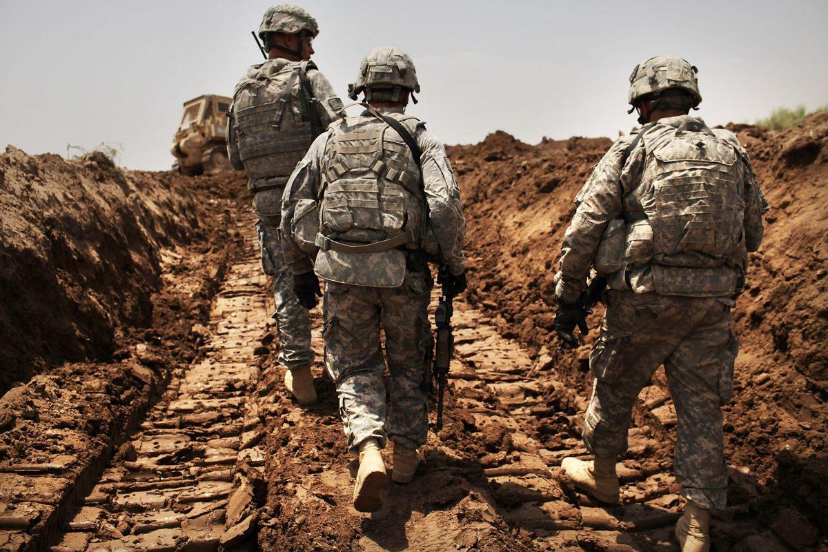 U.S. soldiers with the 3rd Armored Cavalry Regiment patrol a new ditch they dug to protect the base from attack in Iskandariya, Babil Province, Iraq on July 19, 2011. (Spencer Platt/Getty Images)