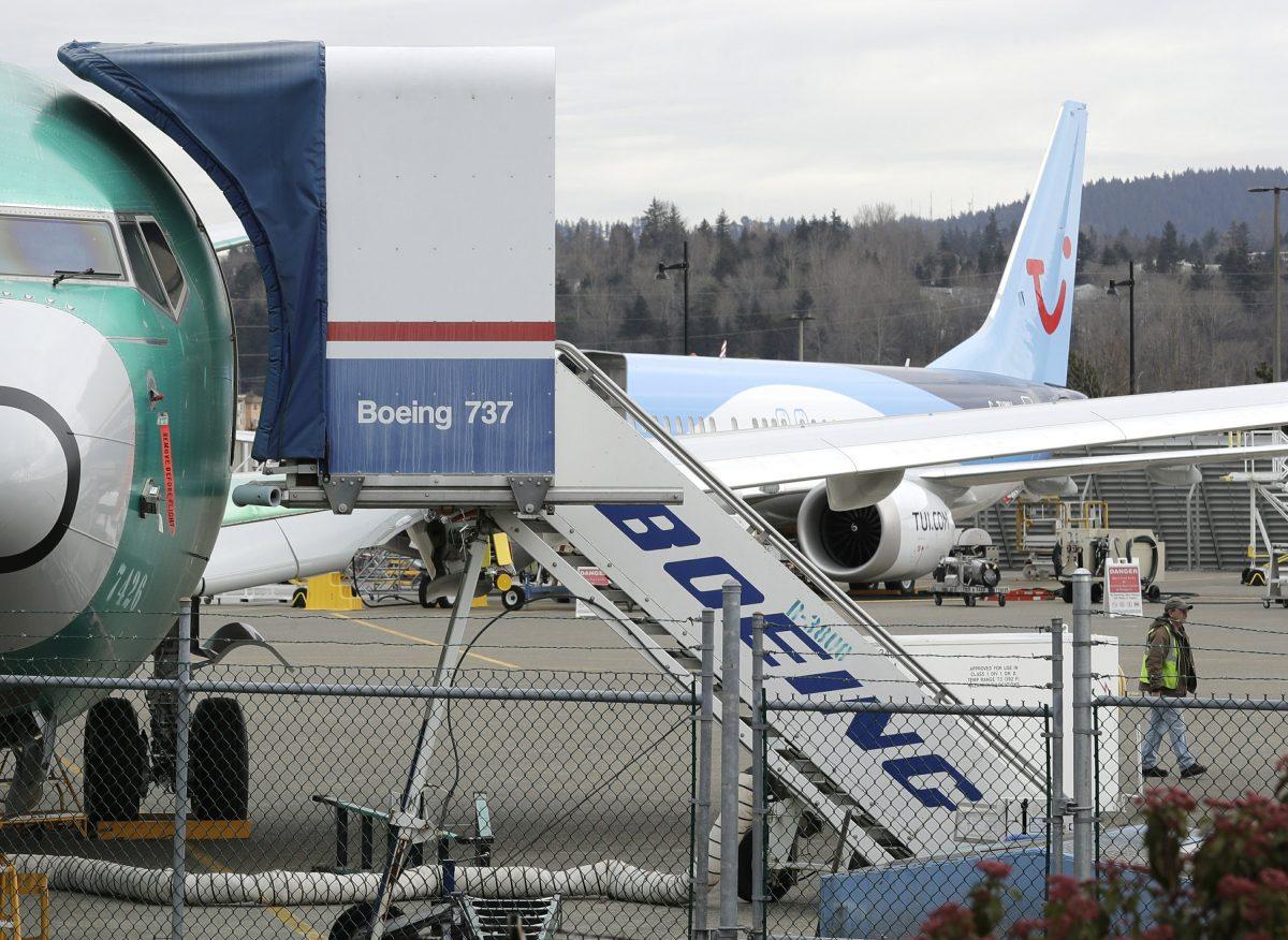 A Boeing 737 MAX 8 airplane sits parked in the background at right at Boeing Co.'s Renton Assembly Plant in Renton, Wash., on March 11, 2019. (Ted S. Warren/AP Photo)