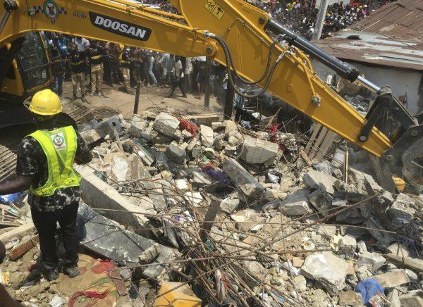 Emergency services attend the scene after a school building collapsed in Lagos, Nigeria, on March 13, 2019. (Sunday Alamba/AP Photo)