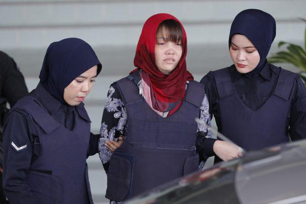 Vietnamese Doan Thi Huong is escorted by police as she leaves Shah Alam High Court in Shah Alam, Malaysia, on March 14, 2019. (Vincent Thian/AP)