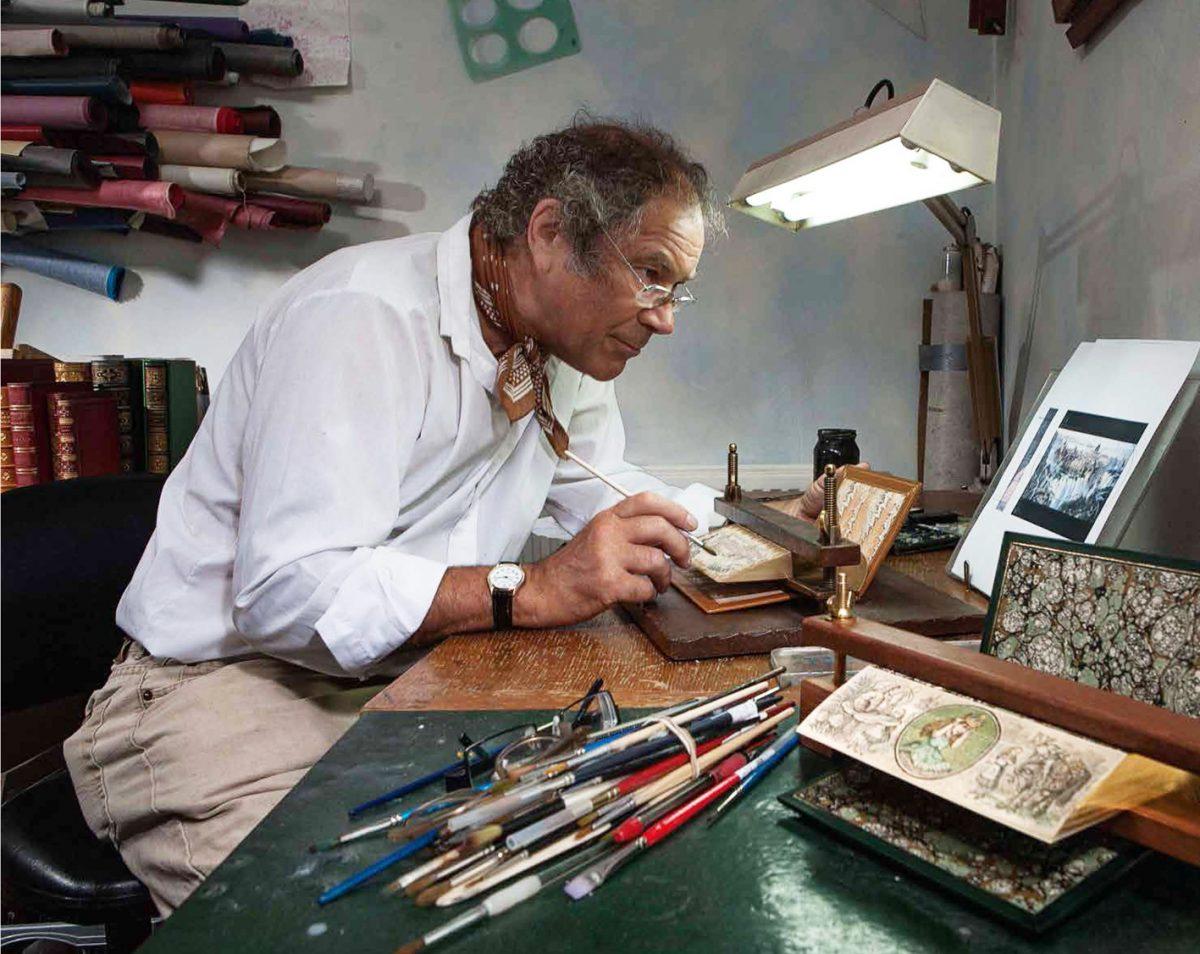 Martin Frost paints vanishing fore-edge paintings in his studio in Worthing, England. (Foredgefrost)