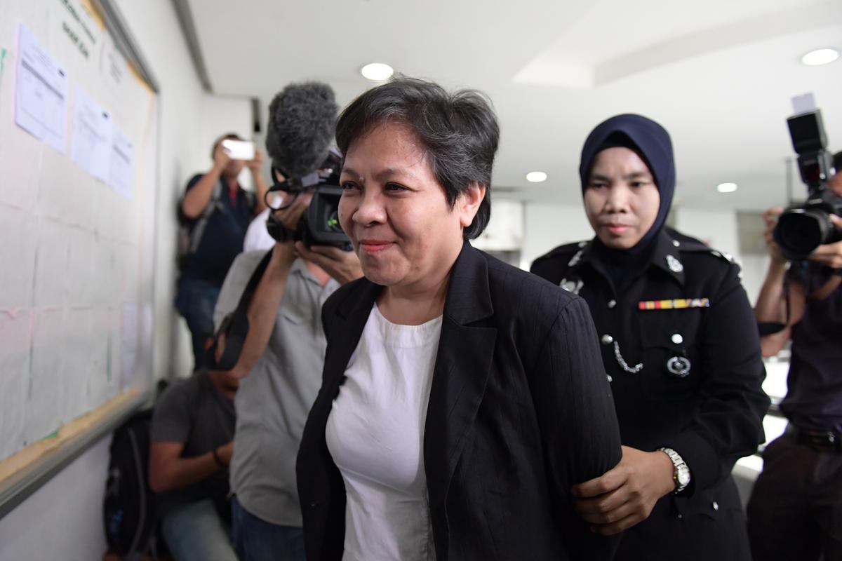 Maria Elvira Pinto Exposto (L), 54, is escorted upon her arrival at the Shah Alam High Court ahead of the verdict in her drugs conviction in Shah Alam, outside Kuala Lumpur, on Dec. 27, 2017.<br/>(Mohd Rasfan/AFP/Getty Images)