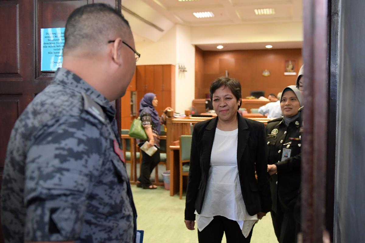 Maria Elvira Pinto Exposto (C), is escorted upon her departure from the Shah Alam High Court after she was cleared of drug trafficking charges in Shah Alam, outside Kuala Lumpur, on Dec. 27, 2017.<br/>(Mohd Rasfan/AFP/Getty Images)