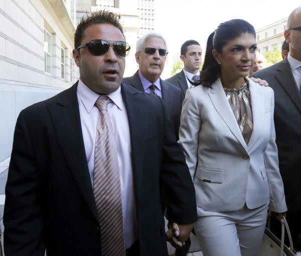 In this July 30, 2013 file photo, Giuseppe "Joe" Giudice(L) and his wife, Teresa Giudice walk out of court in Newark, N.J. On March 14, Joe was released from federal prison and immediately transferred to an immigration detention centre. (AP Photo/Julio Cortez, File)