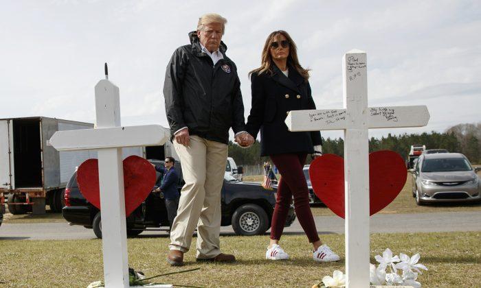 President Donald Trump and first lady Melania Trump visit a line of crosses at Providence Baptist Church in Smiths Station, Ala., as they tour areas where tornados killed 23 people in Lee County, Ala., on March 8, 2019. (Carolyn Kaster/AP Photo)