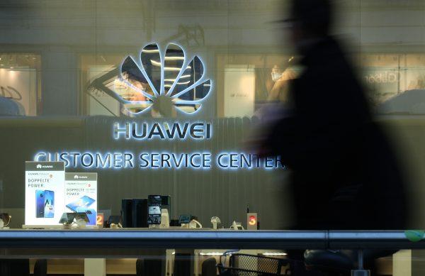 A man walks past a Huawei customer service center in Berlin, Germany on March 12, 2019. (Sean Gallup/Getty Images)