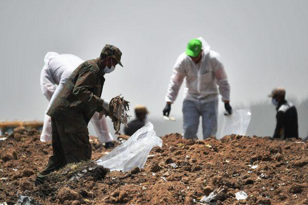 Forensics experts comb through the dirt for debris at the crash site of the Ethiopian Airlines operated Boeing 737 MAX aircraft, at Hama Quntushele village in Oromia region, on March 14, 2019. (Tony Karumba/AFP/Getty Images)