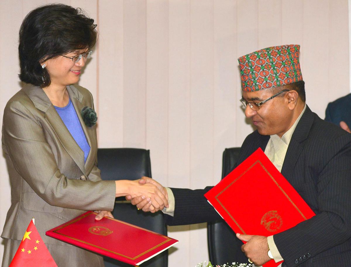 China's Ambassador to Nepal Yu Hong (L) and Nepal's Foreign Secretary Shankar Das Bairagi exchange documents during a signing ceremony relating to the Belt and Road Initiative in Kathmandu on May 12, 2017. (PRAKASH MATHEMA/AFP/Getty Images)