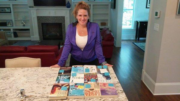 Cyndy Etler with copies of multiple books sent from the publisher that wished to sign her. (Courtesy of Cyndy Etler)