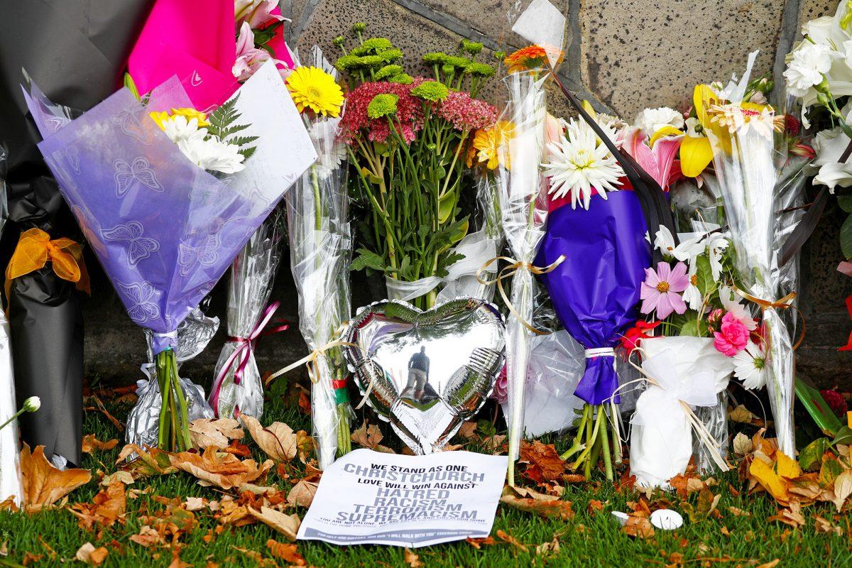 Flowers and signs laid at a memorial for victims of the Christchurch mosque attacks outside Masjid Al Noor in Christchurch, New Zealand, on March 17, 2019. (Jorge Silva/Reuters)