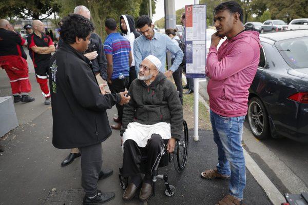 Farid Ahmed, center, a 59-year-old survivor of the March 15 mosque attacks, talks with other relatives outside an information center for families in Christchurch, New Zealand, on March 16, 2019. (Vincent Thian/AP Photo)