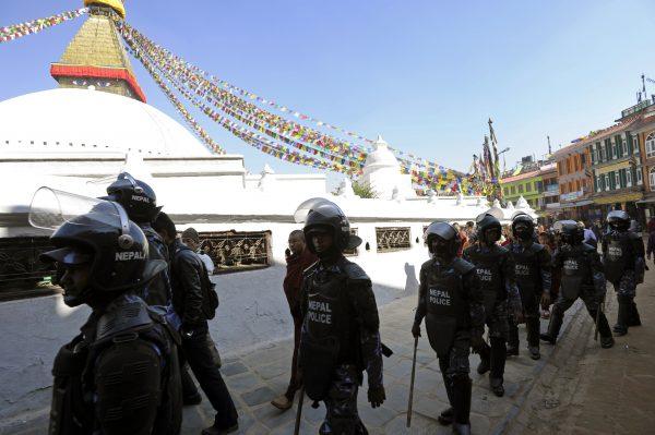 Nepalese police in riot gear keep watch at the Boudhanath stupa following the self-immolation of a monk against rule by the Chinese communist regime in Tibet in Kathmandu on Feb. 13, 2013. (Prakash Mathema/AFP/Getty Images)