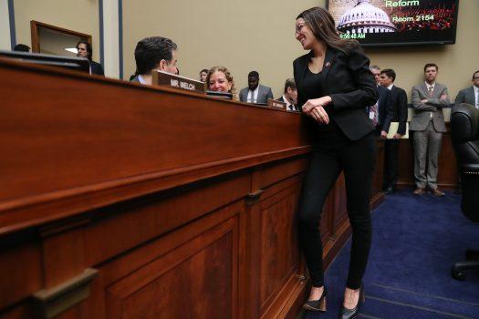 Rep. Alexandria Ocasio-Cortez (D-N.Y.) talks with fellow members during a House Oversight and Reform Committee hearing, on March 14, 2019, in Washington. (Mark Wilson/Getty Images)