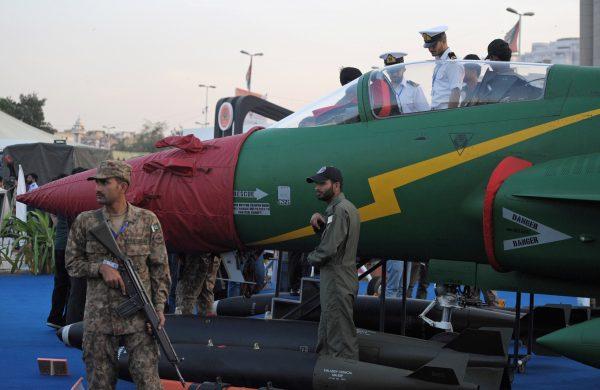 Pakistani soldiers keep watch as a PAC JF-17 Thunder multirole combat aircraft, conceived and initially developed with the help of China, is pictured on static display at the International Defence Exhibition and Seminar (IDEAS) in Karachi on Dec. 3, 2014. (Rizwan Tabassum/AFP/Getty Images)