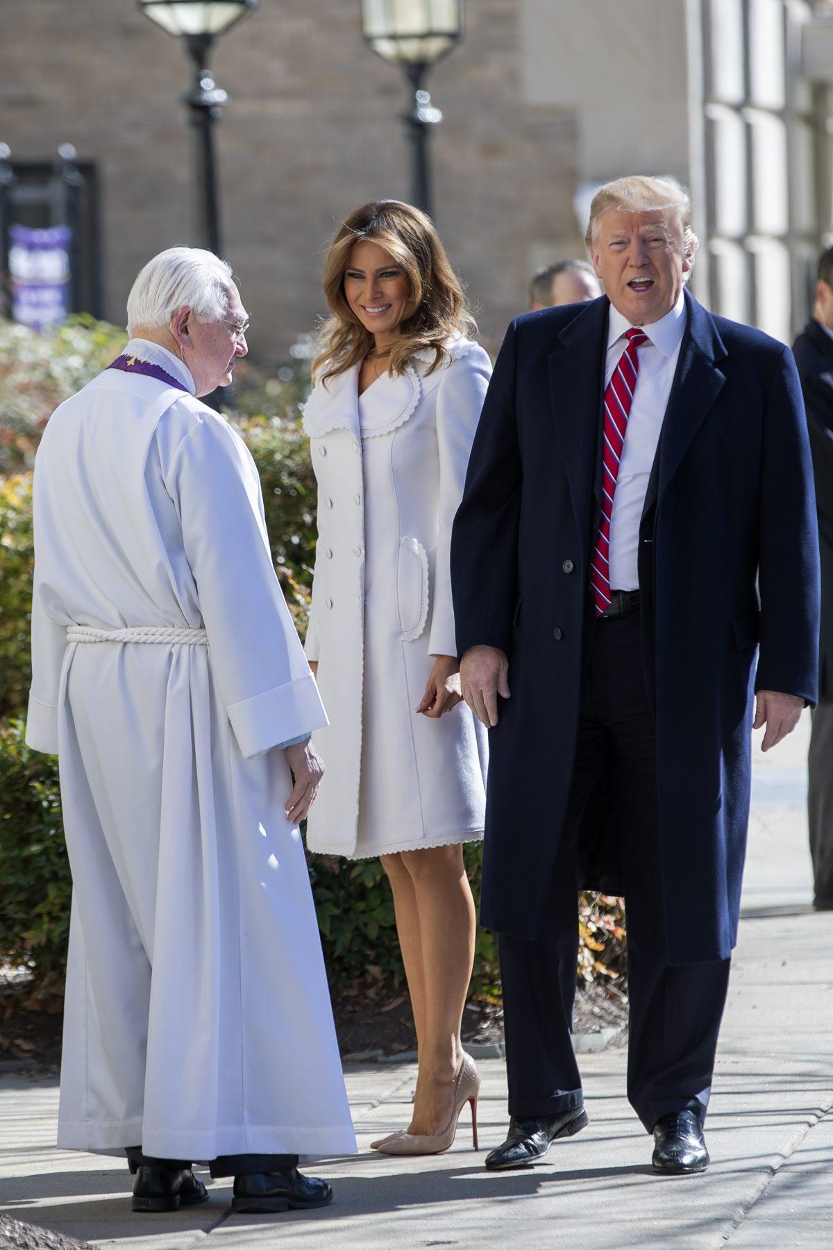 President Donald J. Trump (R) and first lady Melania Trump (C) are greeted by Reverend W. Bruce McPherson (L) as they arrive to attend services at St. John's Episcopal Church in Washington, on March 17, 2019. (Eric Lesser-Pool/Getty Images)