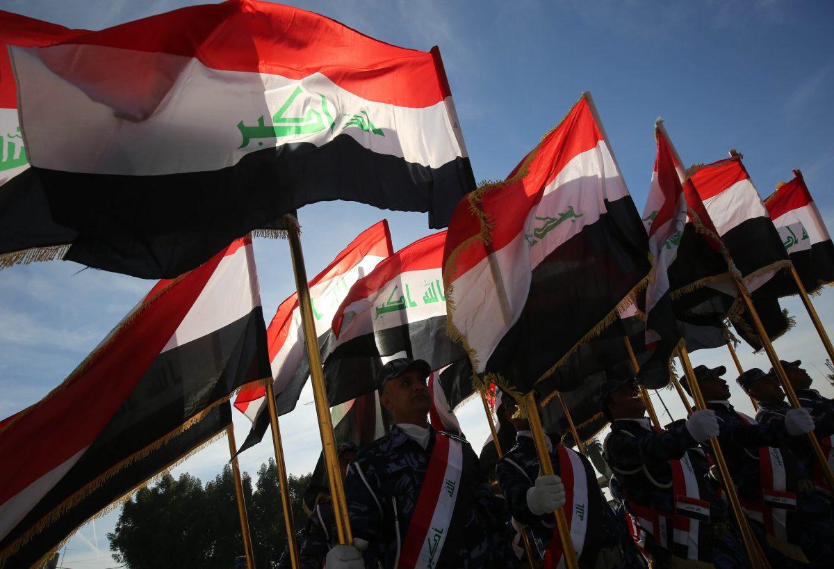 Iraqi policemen hold their national flag and march during a parade in Baghdad on Jan. 10, 2019. (Ahmad Al-Rubaye/AFP/Getty Images)