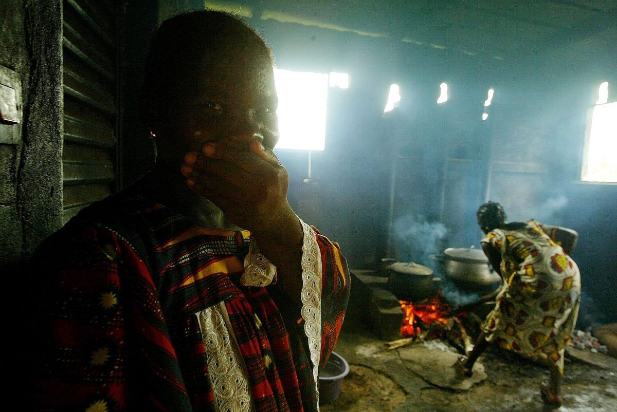 A woman cooks in a hut in Bouake, Ivory Coast, on Oct. 14, 2002. (Pascal Le Segretain/Getty Images)