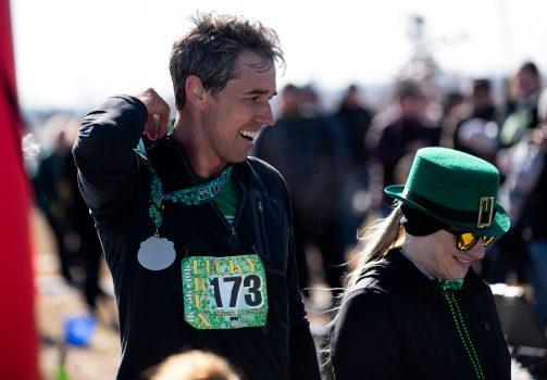 Democratic presidential candidate Beto O'Rourke receives a medal after finishing the Lucky Run 5k race in North Liberty, Iowa, on March 16, 2019. (Stephen Maturen/AFP/Getty Images)