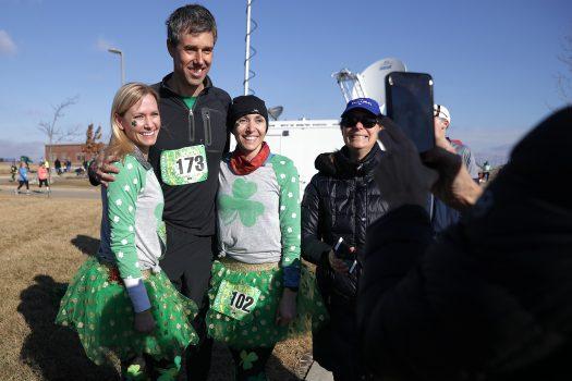 Democratic presidential candidate Robert "Beto" O'Rourke (C) poses for photographs before participating in the Lucky Run 5k race in North Liberty, Iowa, on March 16, 2019. (Chip Somodevilla/Getty Images)