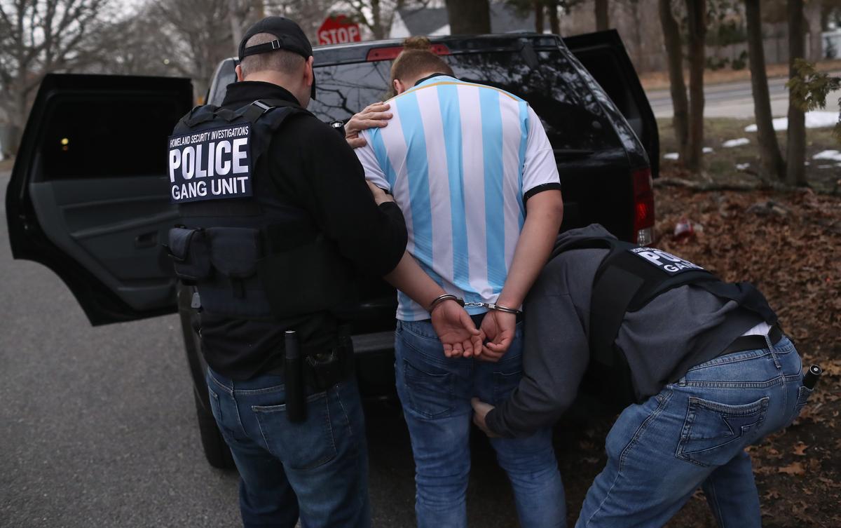 ICE Homeland Security Investigations agents frisk a suspected MS-13 gang member and Honduran immigrant after arresting him at his home in Brentwood, N.Y., on March 29, 2018. (John Moore/Getty Images)