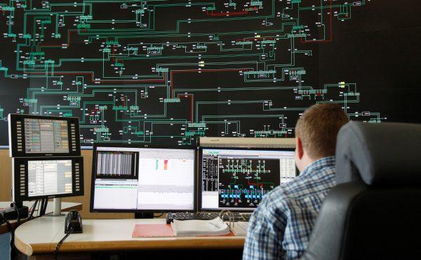An employee of 50Hertz Transmission Company overviews an information board on voltage network in Neuenhagen, Germany on March 6, 2014. (Tobias Schwarz/Reuters)