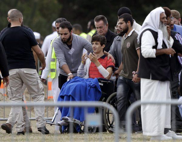 Zaed Mustafa, in a wheelchair, brother of Hamza and son of Khalid Mustafa killed in the March 15 mosque shootings reacts during the burial at the Memorial Park Cemetery in Christchurch, New Zealand, on March 20, 2019. (Mark Baker/AP Photo)