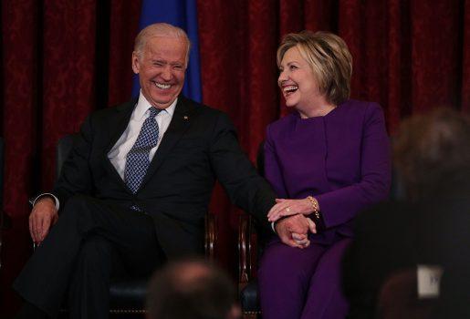 Former Secretary of State Hillary Clinton (R) shares a moment with Vice President Joseph Biden (L) during a leadership portrait unveiling ceremony for Senate Minority Leader Sen. Harry Reid (D-Nev.) on Capitol Hill in Washington on Dec. 8, 2016. (Alex Wong/Getty Images)