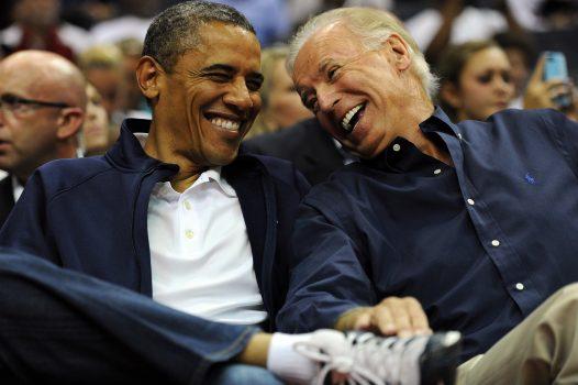 President Barack Obama and Vice President Joe Biden share a laugh as the US Senior Men's National Team and Brazil play during a pre-Olympic exhibition basketball game at the Verizon Center in Washington on July 16, 2012. (Patrick Smith/Getty Images)