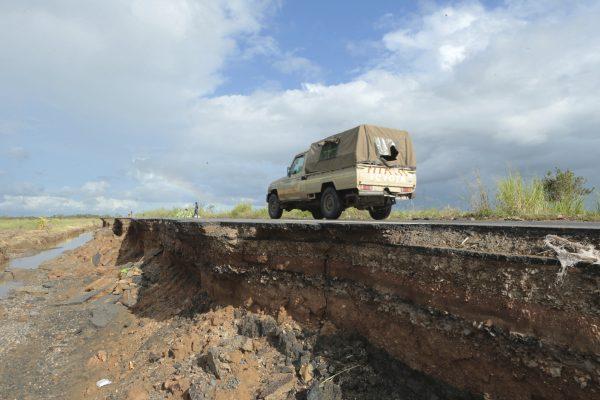 A vehicle passes through a section of the road damaged by Cyclone Idai in Nyamatanda, Mozambique, on March 21, 2019. (Tsvangirayi Mukwazhi/AP Photo)