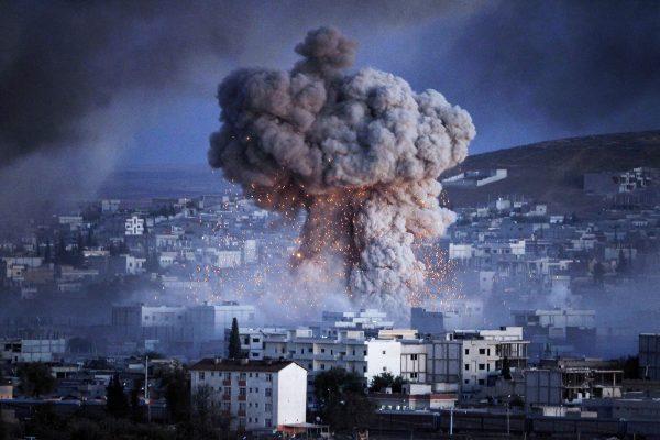 An explosion rocks the Syrian city of Kobani during a reported suicide car bomb attack by ISIS terrorists on a People's Protection Unit (YPG) position in the city center, on Oct. 20, 2014. (Gokhan Sahin/Getty Images)