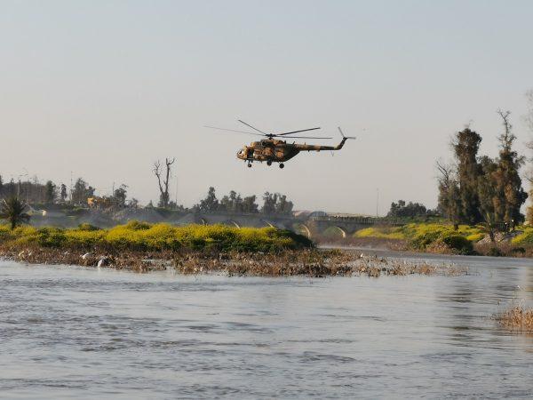 An Iraqi rescue helicopter searches for survivors at the site where an overloaded ferry sank in the Tigris river near Mosul in Iraq, on Mar. 21, 2019. (Stringer/Reuters)