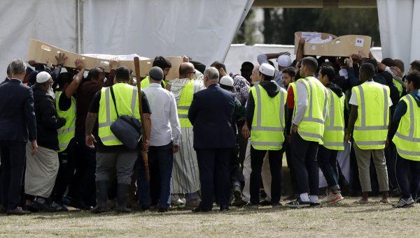 Mourners carry the bodies of father and son Khaled and Hamza Mustafa, victims of the March 15 mosque shootings for burial at the Memorial Park Cemetery in Christchurch, New Zealand, on March 20, 2019. (Mark Baker/AP Photo)