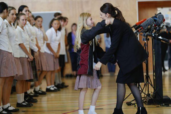 New Zealand's Prime Minister Jacinda Ardern, right, hugs and consoles a student during a high school visit in Christchurch, New Zealand, on March 20, 2019. (Vincent Thian/AP Photo)