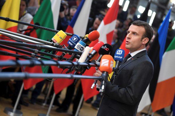 French President Emmanuel Macron talks to the media as he arrives for a European Union leaders summit in Brussels on March 21, 2019. (Toby Melville/Reuters)