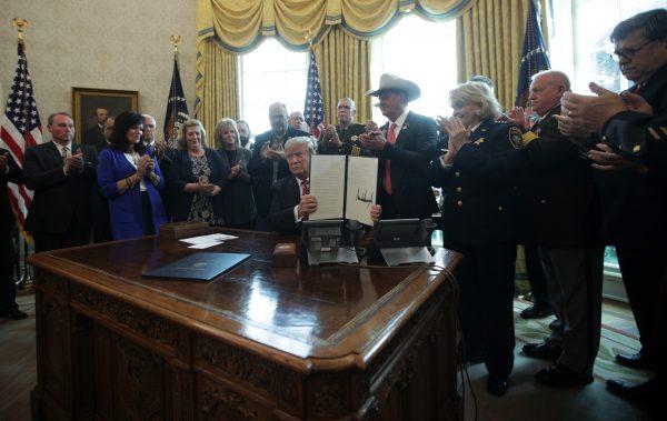 President Donald Trump shows the executive veto of the national emergency resolution in the Oval Office of the White House on March 15, 2019. (Alex Wong/Getty Images)