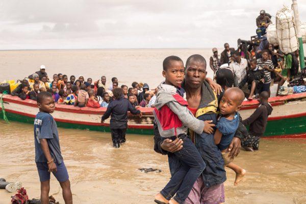 In this photo supplied by the Red Cross Red Crescent Climate Centre survivors of Cyclone Idai arrive by rescue boat in Beira, Mozambique, on March 21, 2019. (Denis Onyodi—Red Cross Red Crescent Climate Centre via AP)
