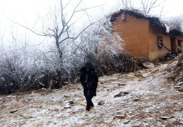 Wang Fuman, also known as "Frost Boy," walks on the road in Ludian in China's southwestern Yunnan Province on Jan. 12, 2018. (AFP/Getty Images)