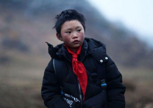 A Chinese elementary school boy named Wang Fuman in China's southwestern Yunnan Province on Jan. 11, 2018. The red scarf indicates that he is a member of the Chinese Communist Young Pioneers League. (AFP/Getty Images)