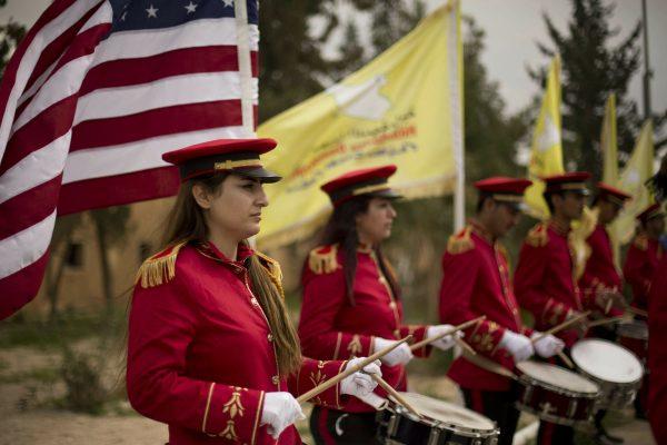 A military band performs ahead of a ceremony at al-Omar Oil Field marking the U.S.-backed Syrian Democratic Forces (SDF) capture of Baghouz, Syria, after months of fighting to oust ISIS terrorists, on March 23, 2019. (Maya Alleruzzo/Photo via AP)