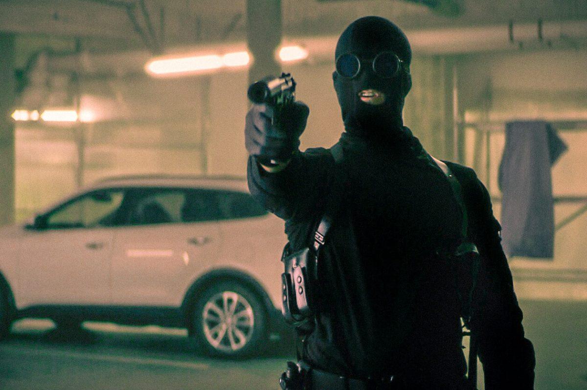 A masked gunman and bank robber in a scene from “Dragged Across Concrete.” (Cinestate/Lionsgate)