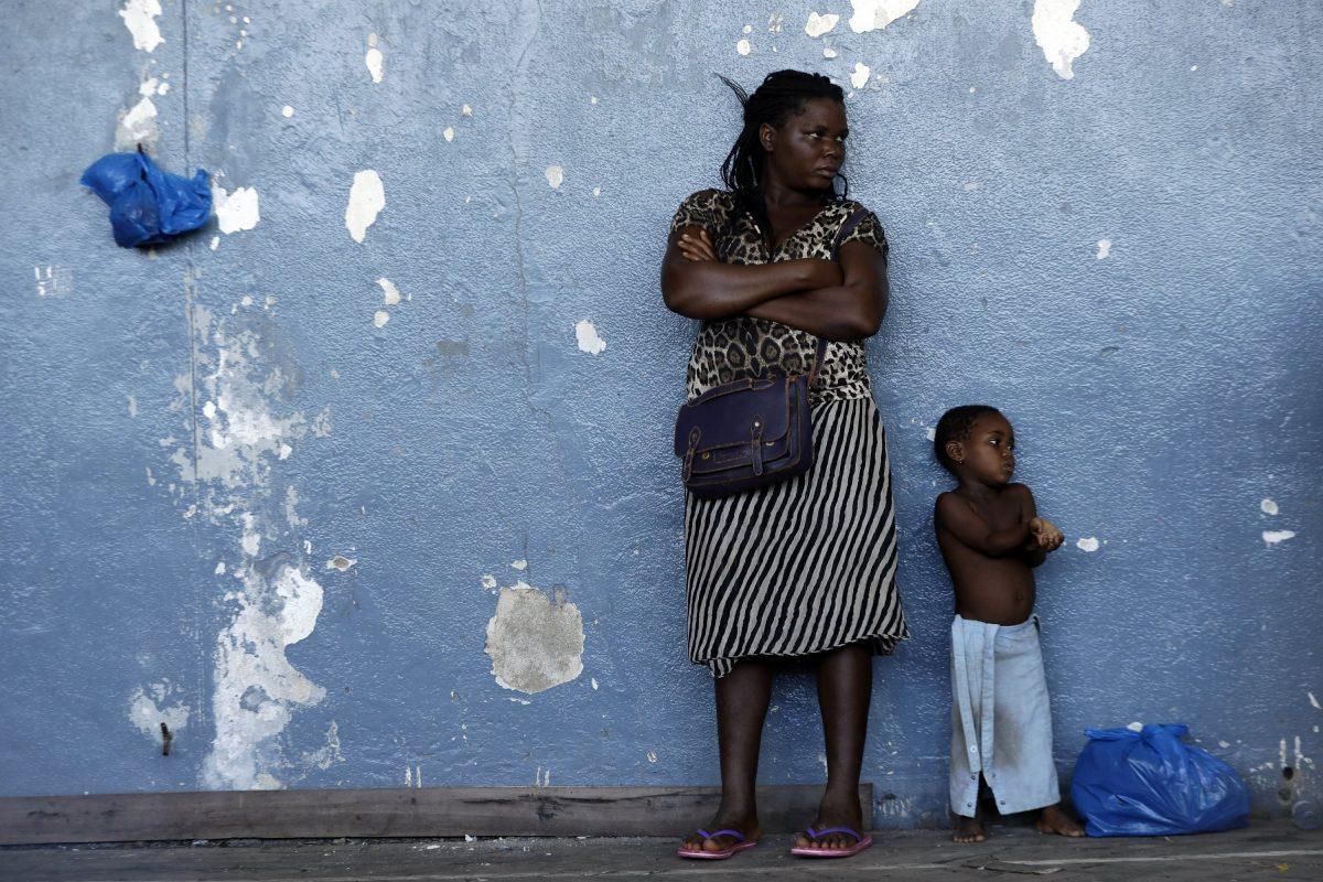 A woman and her child send against the wall at a displacement centre in Beira, Mozambique, on March 22, 2019. (Themba Hadebe/AP Photo)